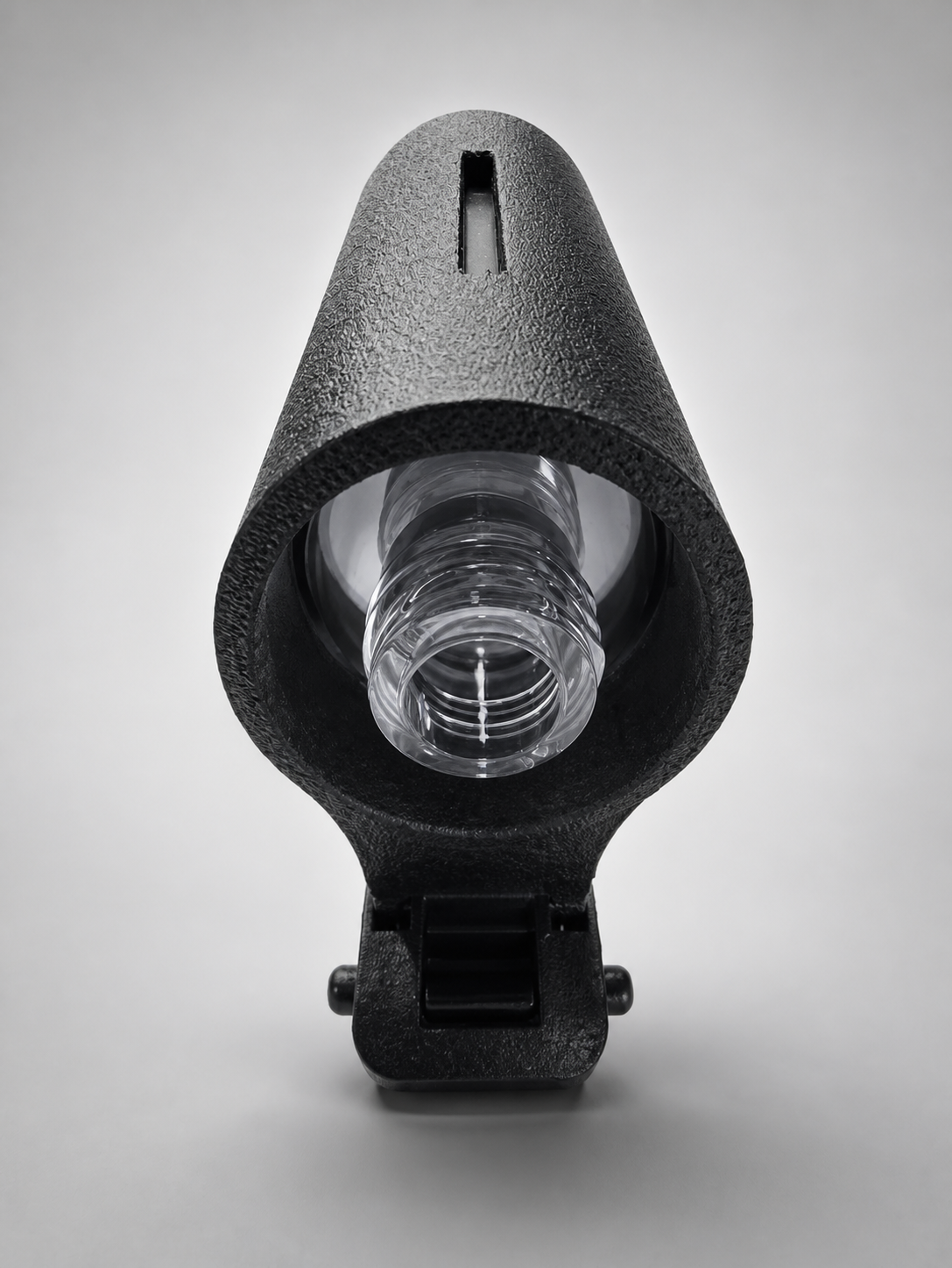 Refillable vacuum-style bottle removed from the TactiClean duty vest sanitizer holder